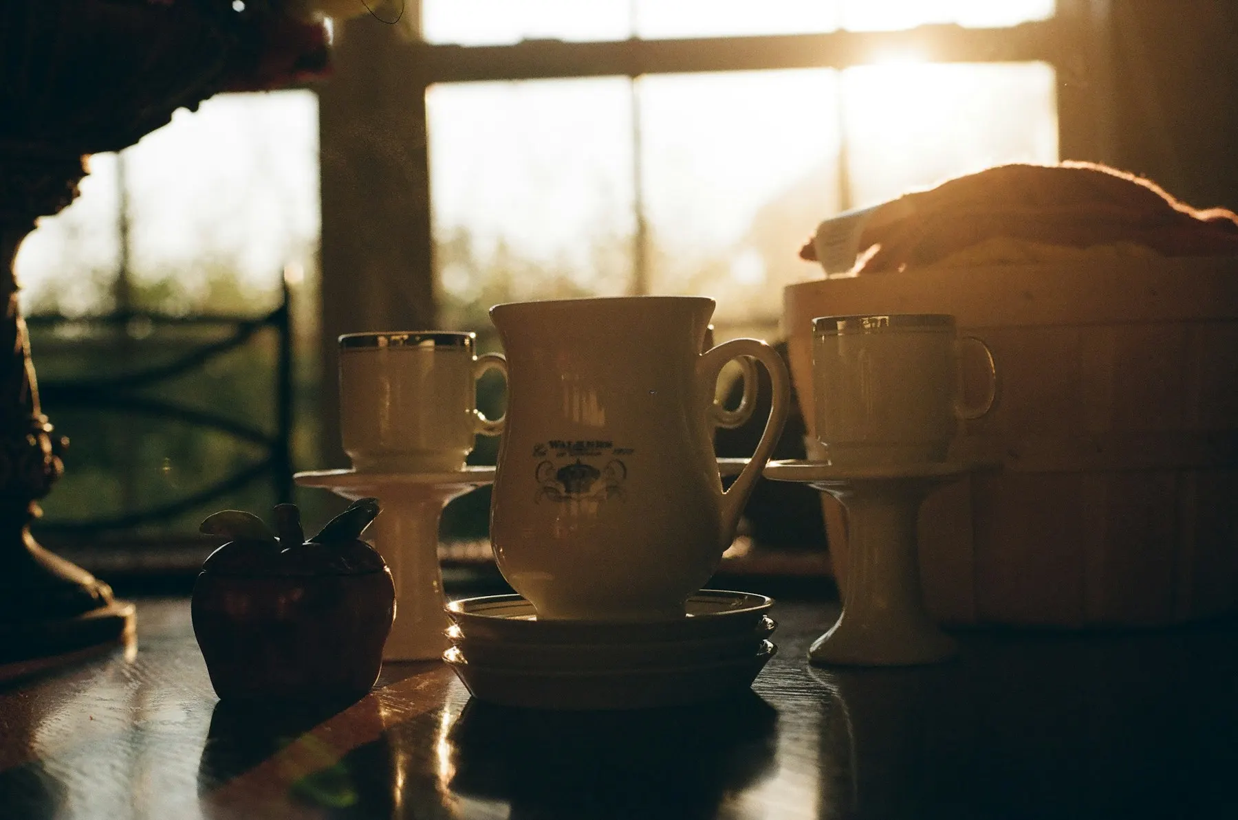 Mugs on a sunlit café windowsill